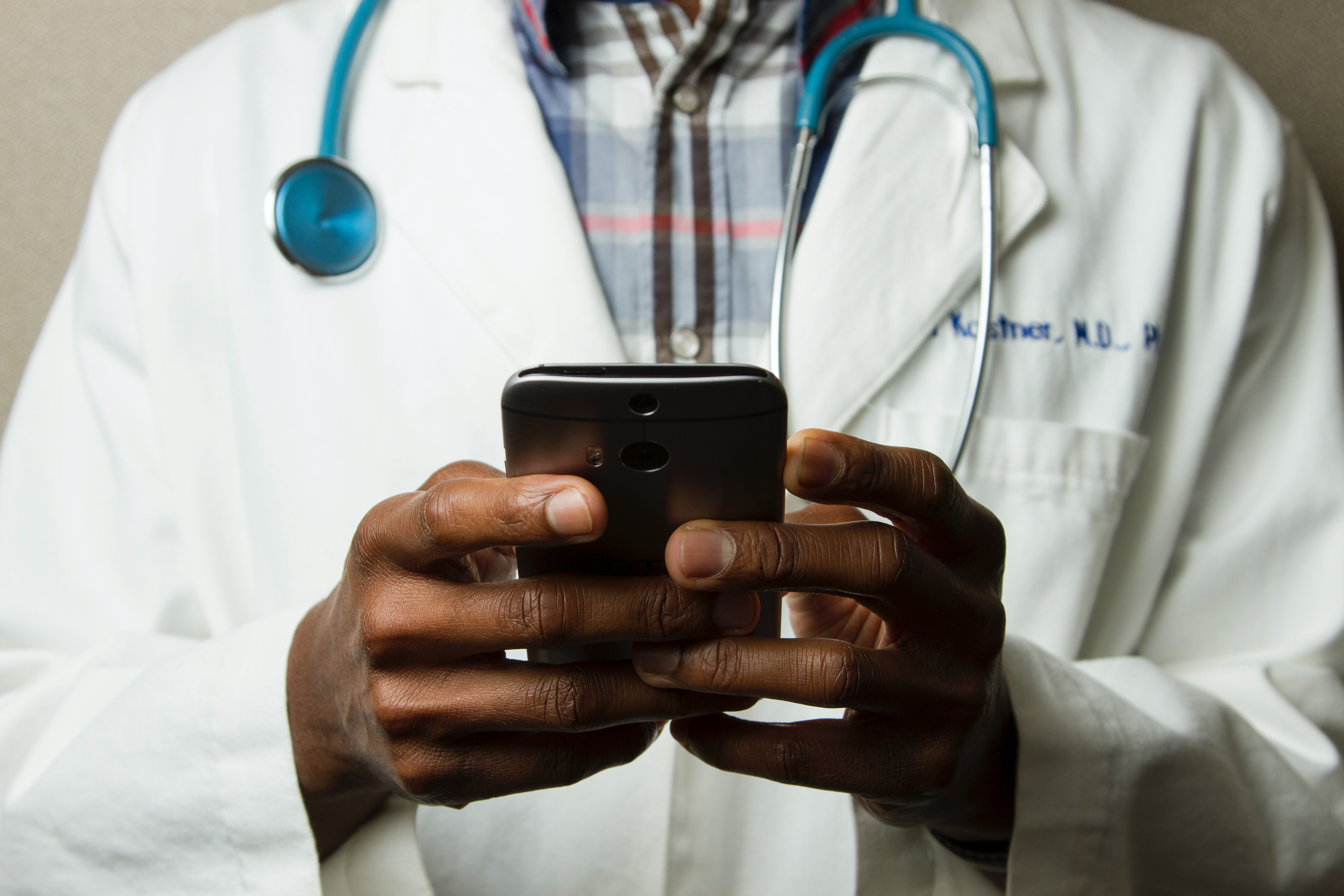 Doctor with phone for telehealth call